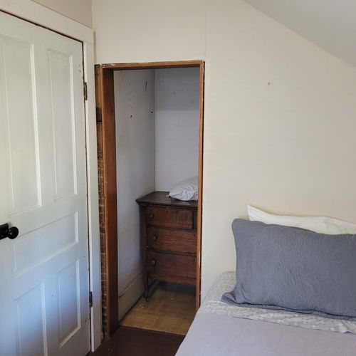BEDROOM #3 (SECOND FLOOR):  Features 2 twin beds, a nightstand, lamp, and a closet.