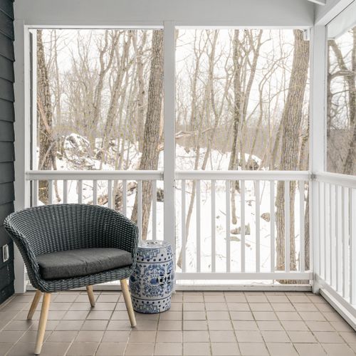 Additional seating on the screened in porch.