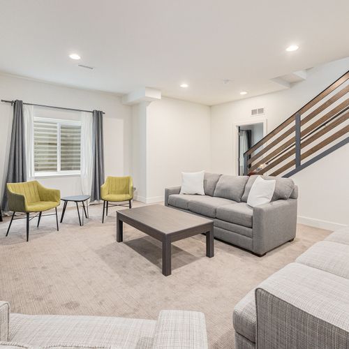 Laid-back, carpeted comfort meets board game fun in this downstairs living area.