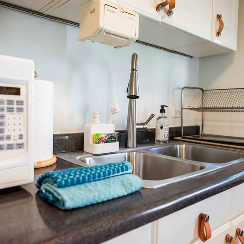 Everything you need for easy meal prep and cleanup is right here. This practical kitchen area includes a microwave, ample sink space, and dish rack.