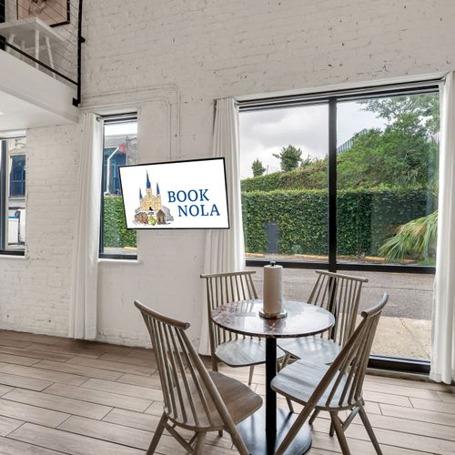 Charm meets natural radiance as the living room’s expansive windows invite the essence of New Orleans right inside