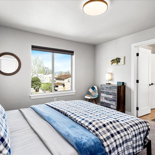 - cozy plaid bedding and soft lighting make this bedroom a warm and inviting retreat