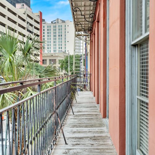 Classic wrought-iron balcony dripping w/ French Quarter character.