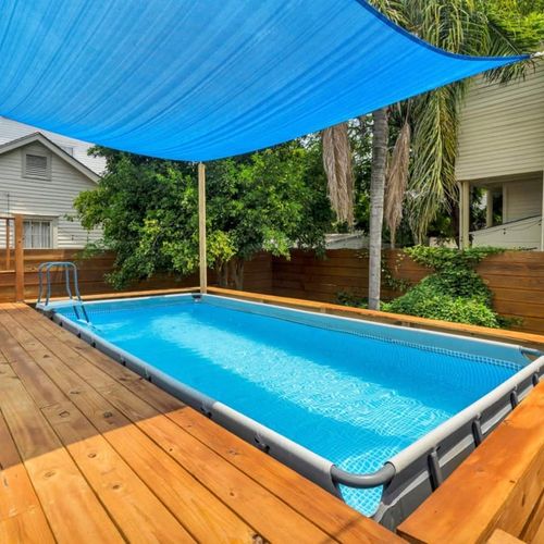 Sparkling outdoor pool on a spacious wooden deck — your private backyard escape.