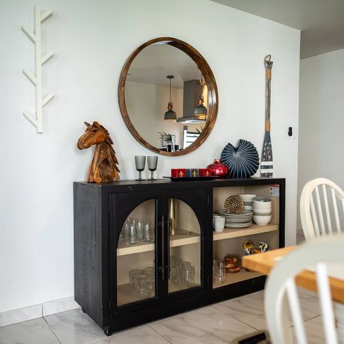 Step into style! Our entryway features a beautiful round mirror, a charming console cabinet with glassware, and unique decorative accents that welcome you to your Malolos retreat.