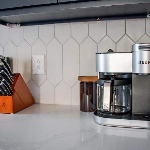 The kitchen is stocked with high quality wares like this Keurig duo coffee maker and Zwilling knife set.