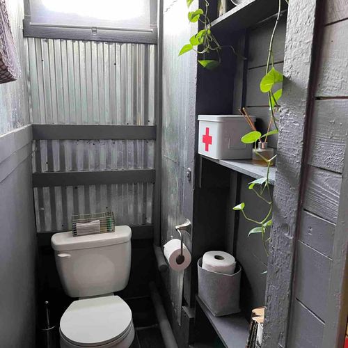 Private commode tucked into a clean, well-designed space.