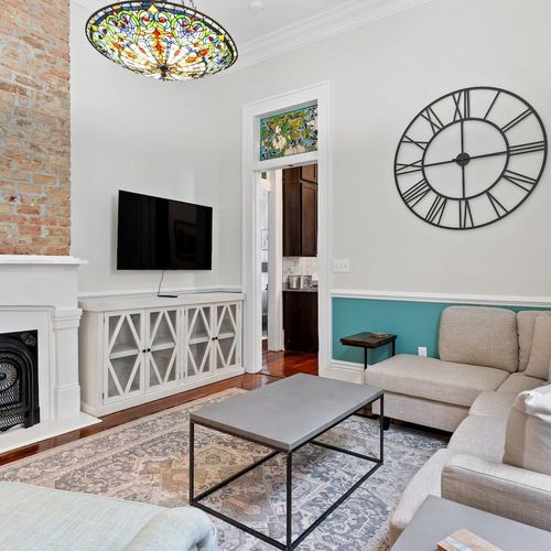 Airy living room w/ a Smart TV & classic white fireplace for relaxed evenings in.