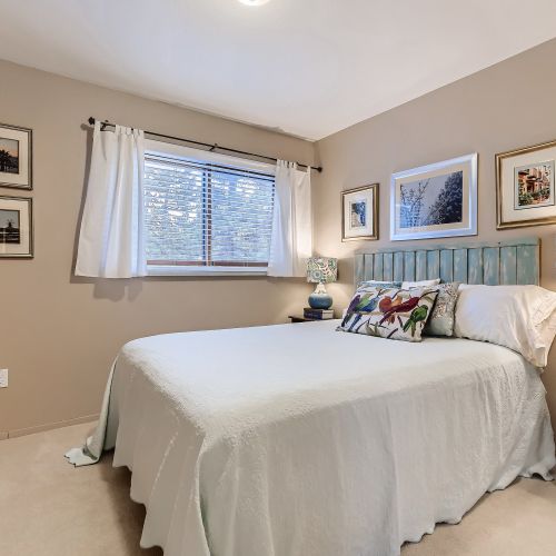 This bedroom is equipped with a queen bed, wood side tables with lamps and black-out curtains for a good night's rest.