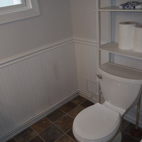 Bathroom #1  (downstairs):  the downstairs has a convenient half-bath next to the laundry room. It has a toilet, pedestal sink, and mirror.