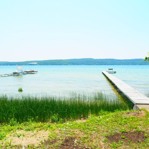 Exterior:  another view of the backyard, private lakefront, and large dock