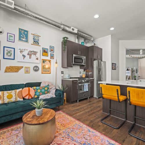 Open concept layout with bright seating, modern kitchen, and thoughtful design throughout