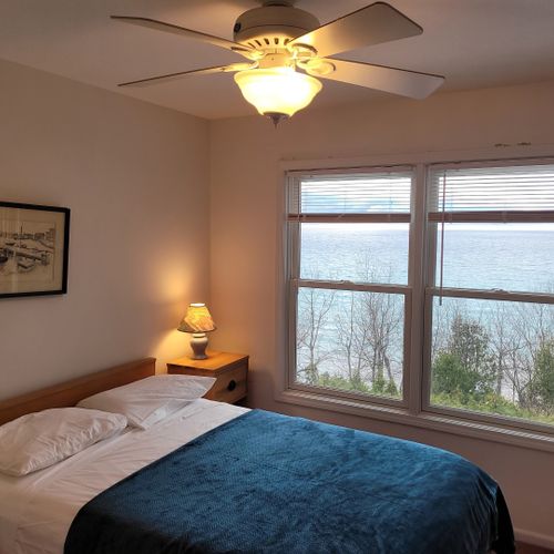 Bedroom #3 (upper level):  features a full-size bed, ceiling fan, closet, and great views of lake michigan.