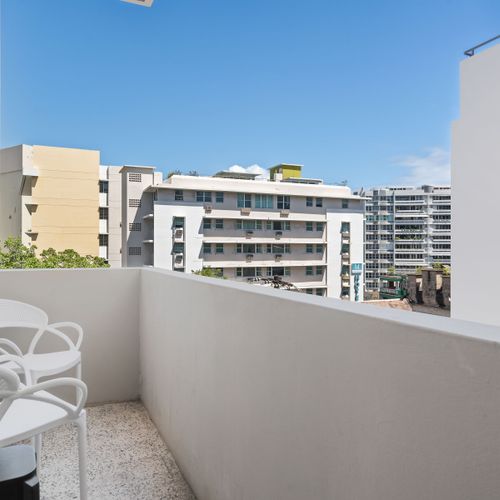 Step out onto the private balcony and take in a charming view of the vibrant neighborhood. It’s an excellent spot for a quiet moment or an evening breeze.