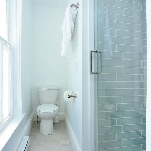 The delmonico's connected bathroom features a private toilet and walk-in shower. Shampoo, conditioner, and soap are provided.