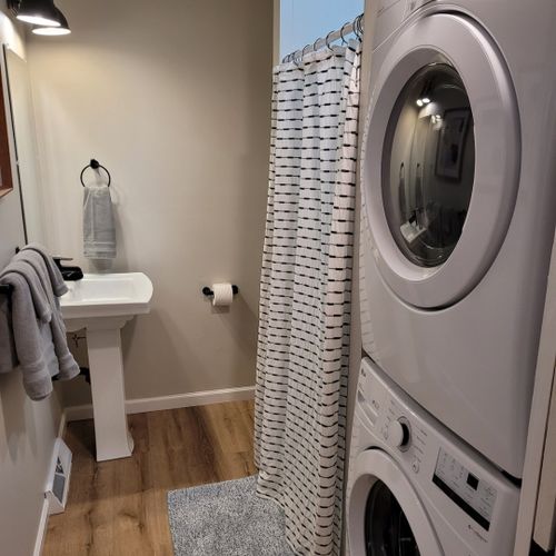 Bathroom #2:  second full bathroom that also serves as the laundry room having a stacked washer and dryer in it.