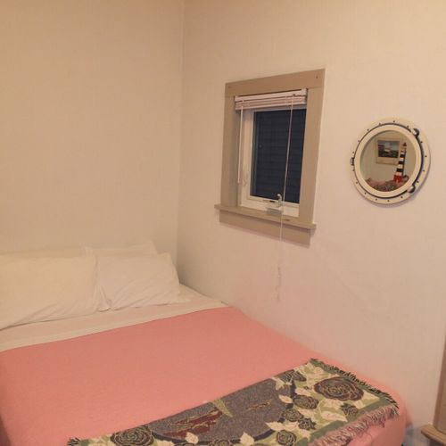 Bedroom #1 (main floor):  features a queen-size bed, mirror, dresser, and closet.
