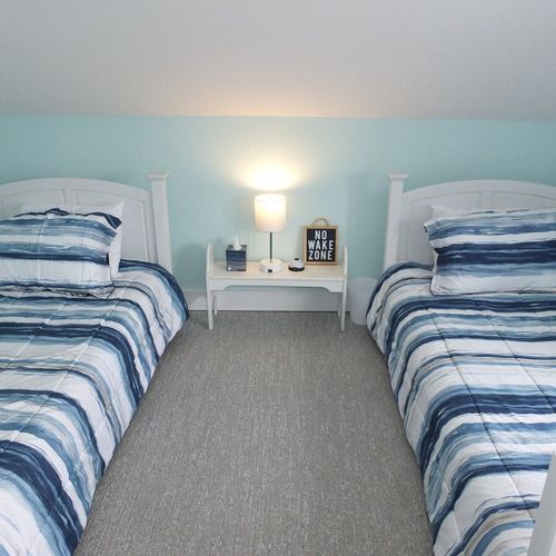 Upstairs living room:  this could be considered to be a third bedroom, but it does not have a private entrance. It is located at the top of the stairs to the second floor. It has 2 twin-size beds, a nightstand, and a closet.