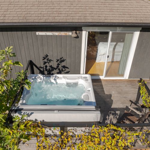 Unwind in the private hot tub just steps from the bedroom, Soak under open skies, surrounded by greenery, and let the day melt away—perfect for peaceful mornings or starlit evenings on the deck.
