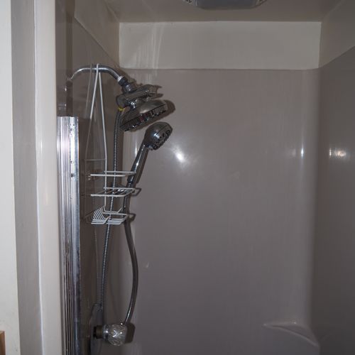 Bathroom:  small, but full bathroom, with entrance from the living room. Includes sink, mirror, toilet, and shower.