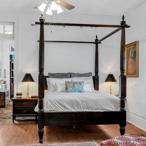 Spacious four-poster primary bedroom w/ elegant details throughout.