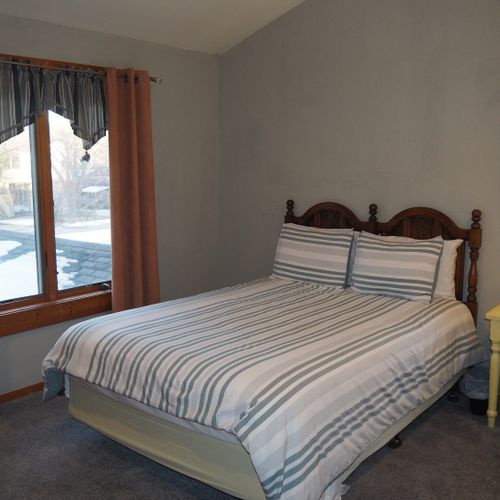 Bedroom #2 (second floor):  features a queen-size bed, desk with chair, mirror, and a large closet.