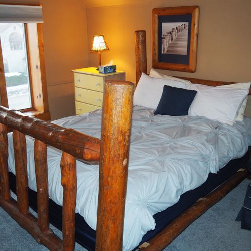 Bedroom #4 (second floor):  features a queen-size bed, private television, sofa bed, comfy chair, ceiling fan, baby crib, and a dresser.