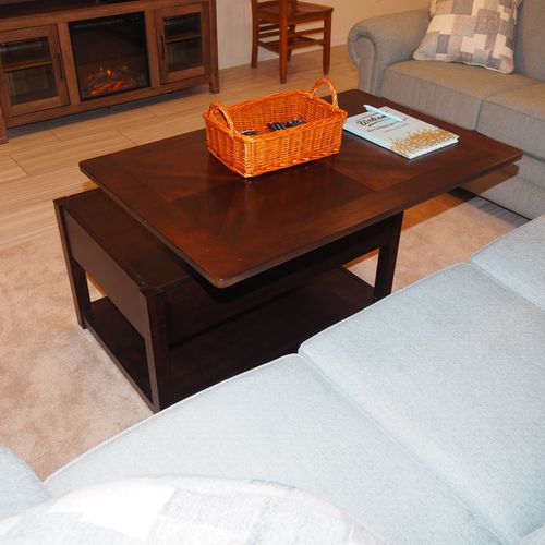 Living room:  the apartment has a very comfortable living room with a sleeper sofa, comfy chair, ceiling fan, table, and television.