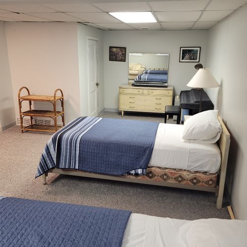 Lower level:  the lower level of the home has 2 single beds, a dresser, a sofa, half-bath, and a large laundry room.