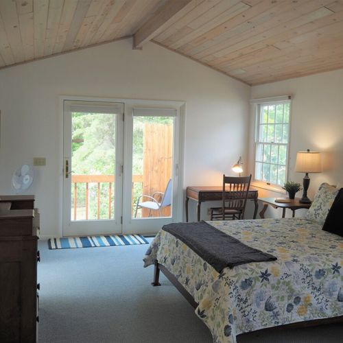 Bedroom #1 (main floor):  huge master bedroom featuring a king-size bed, desk, private television, private en suite full bathroom, chairs, dresser, walk-in closet, and even a private laundry room!