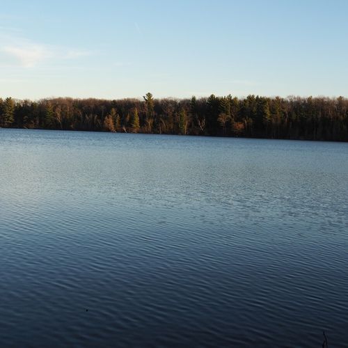 This is a november, 2020 photo of beautiful green lake from the private lake access area. Note that the opposite side of the lake is a nature preserve and new construction is not permitted there.