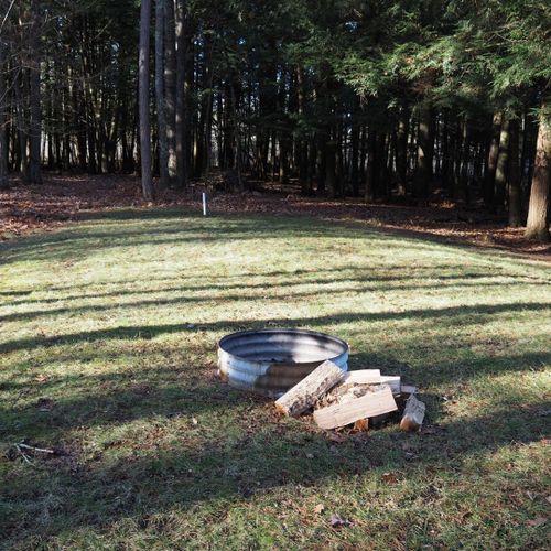 The house has a nice fire ring in the backyard.