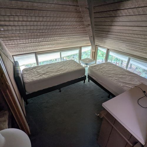 Bedroom #2:  one of the two upstairs bedrooms with two twin beds, a dresser, and a closet with extra blankets and pillows
