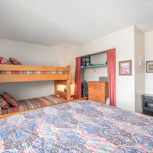 Charming second bedroom offering twin beds + queen bed. Ideal for friends or family.