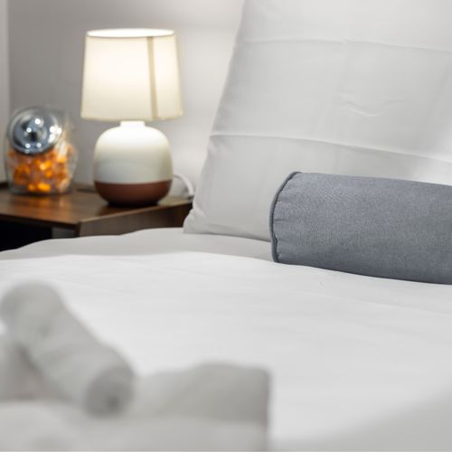 Bedside lamp and earplugs provided for a comfortable sleep.