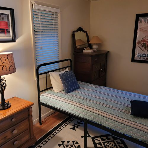 BEDROOM #3 (FIRST FLOOR):  Features two twin beds, a nightstand, lamp, dresser, and closet