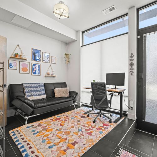 Futon bed by the office comfortably sleeps two, perfect for flexible stays