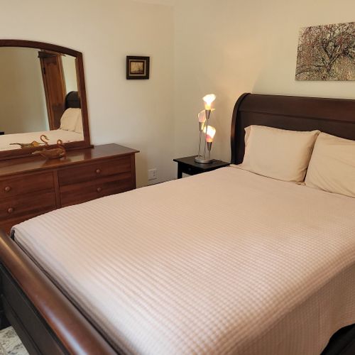 Bedroom #3 (second floor):  features a queen-size bed, dresser, large mirror, nightstand, and closet.