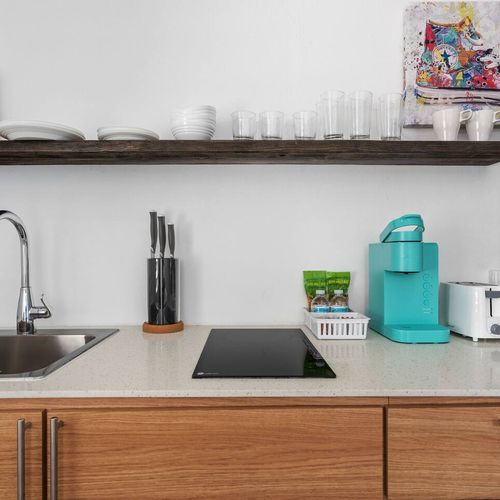 Prepare meals in this well-equipped kitchen with a refrigerator and microwave.