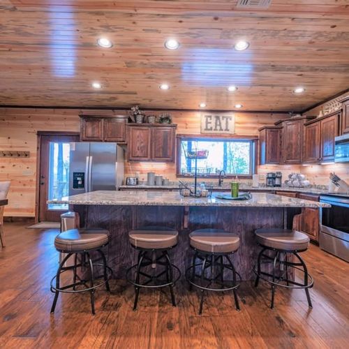 4 additional seats can be found at the bar top in the kitchen.