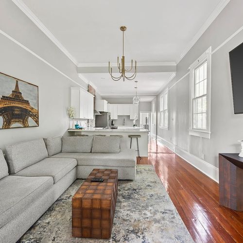 Spacious and stylish, this open-concept living room is perfect for relaxation and entertaining, featuring modern comforts and classic charm in the heart of New Orleans.