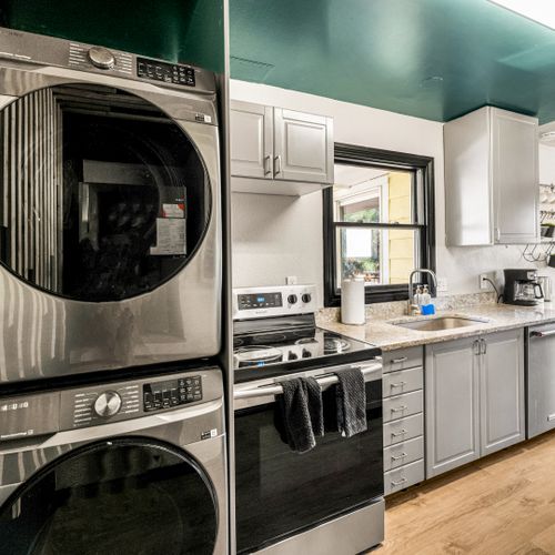 The laundry area is equipped with a washer and dryer to refresh your wardrobe while traveling