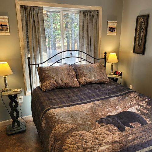 Bedroom #2 (second floor):  features a queen-size bed, nightstands, lamps, and a closet.