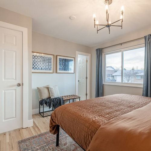 - wake up to daylight streaming through wide windows dressed in elegant curtains
- cushioned bench with soft throws creates a cozy corner to read or unwind
- framed abstract art and neutral tones set a relaxed, modern atmosphere