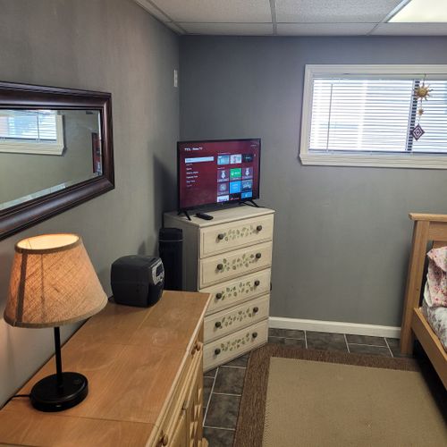 Bedroom:  cute bedroom with a twin-on-full bunk bed, electric heater, fan, 2 dressers, closet, lamp, and a television.