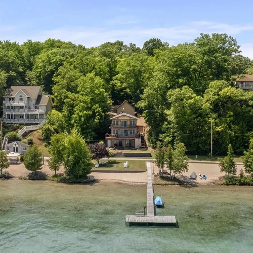 OVERVIEW:   Aerial shot of the incredible home and it's gorgeous private beach, lakefront, and dock!