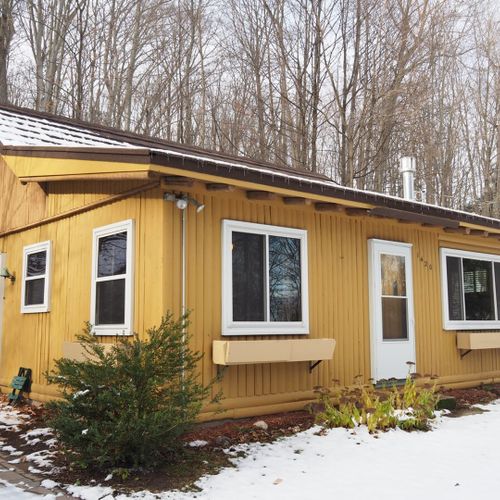 Exterior:  the outside of the cabin in the winter.