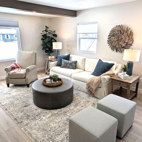 LIVING ROOM:  The home has a gorgeous newly-decorated living room with a sofa, comfy chairs, ottoman, and large screen television