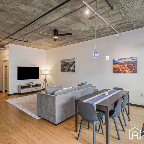 - gather around the large table under pendant lights for meals, work, or games
- lounge area and tv offer easy relaxation in an open industrial modern layout
- smartly designed for entertaining or remote work with stylish urban comfort