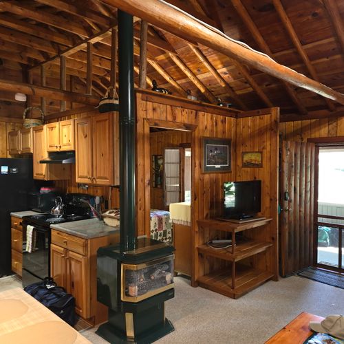Living room:  the cabin has a very comfy and cozy living room with a sofa, comfy chair, gas fireplace, coffee table, and live streaming television with roku